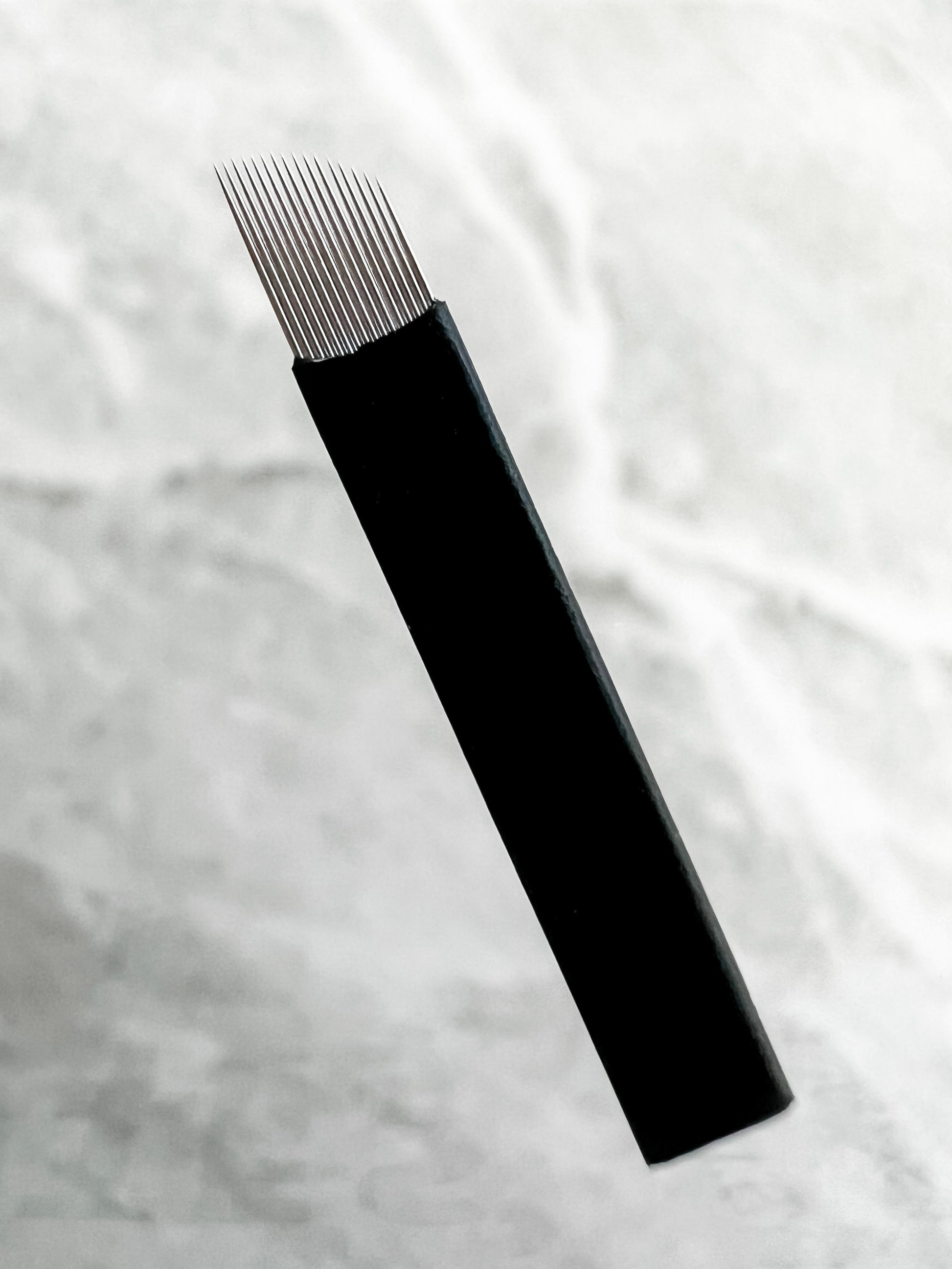 curved flat microblading blade with slant needle configuration for smooth eyebrow hairstroke tattooing